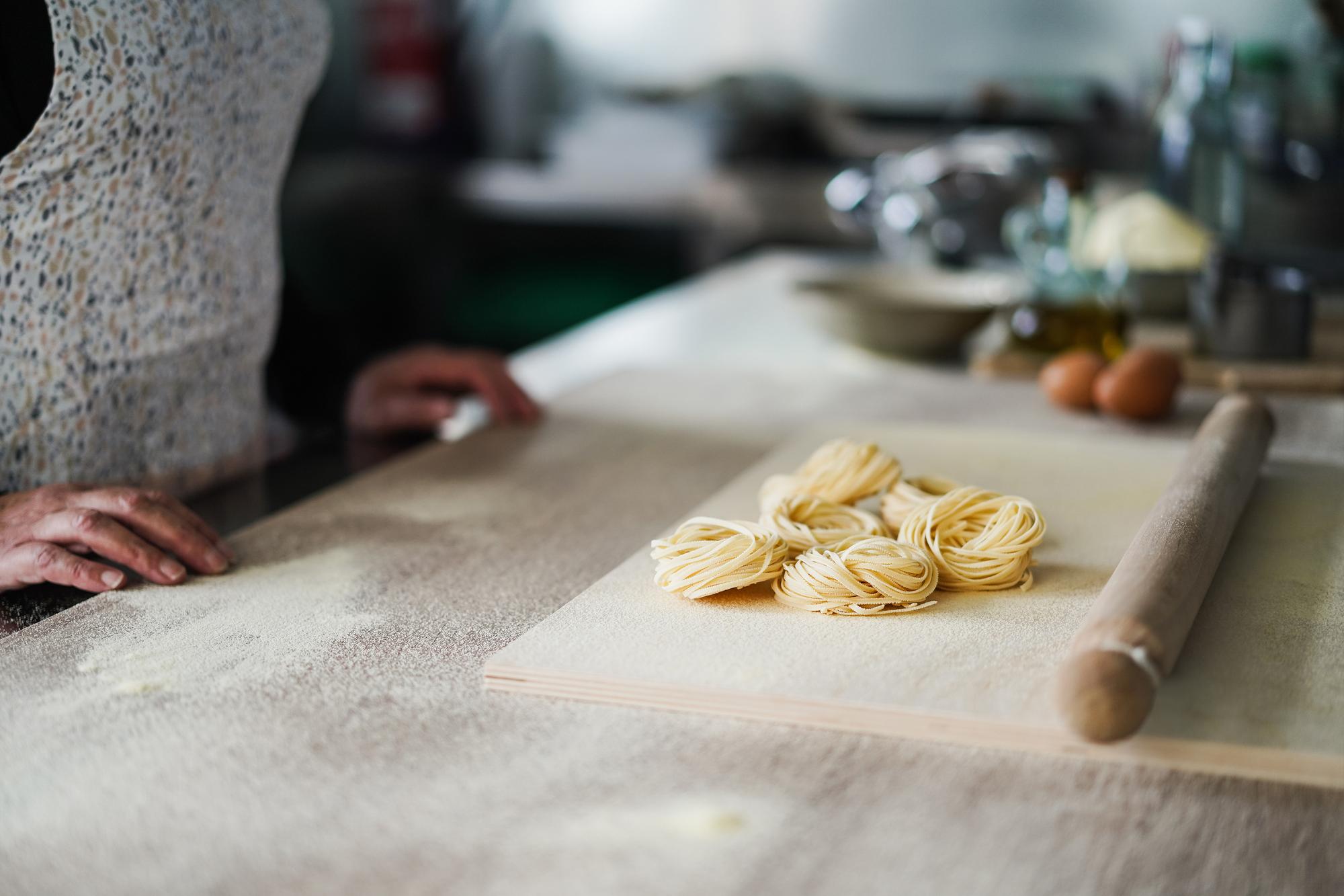Close-up hands preparing pasta dough